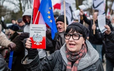 Eine Frau zeigt bei einer Demonstration die Verfassung von Polen. Foto: Wojtek Radwansk | AFP
