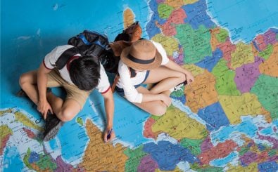 Zwei Menschen planen eine Weltreise. Foto: Torwaistudio / Shutterstock.com