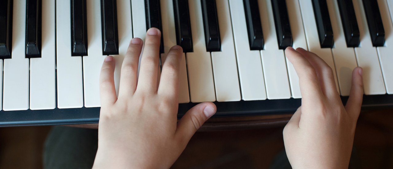 shutterstock: https://www.shutterstock.com/image-photo/close-childs-hand-playing-piano-favorite-1729636717