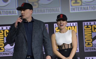Kevin Feige, links im Bild, und Scarlett Johansson, rechts, lachend, stehen nebeneinander auf einer Bühne der Comic Con San Diego und stellen den Film „Black Widow“ vor. (Foto: afp / Chris Delmas)