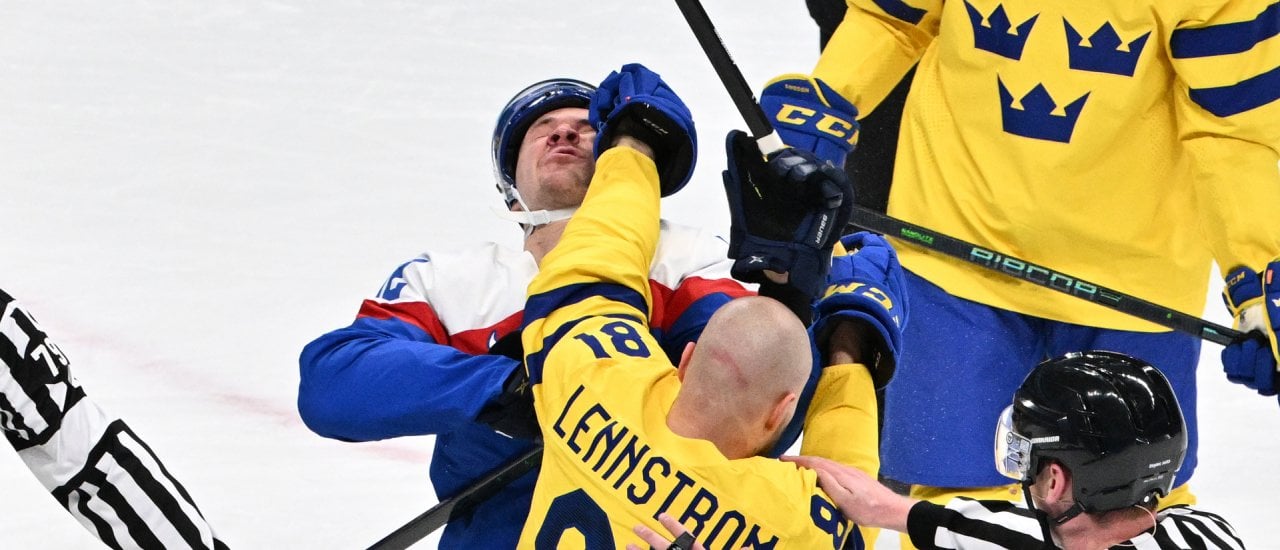 Slovakia’s Milos Kelemen (back) and Sweden’s Theodor Lennstrom engage in a fight during their men’s preliminary round group C match of the Beijing 2022 Winter Olympic Games ice hockey competition, at the Wukesong Sports Centre in Beijing on February 11, 2022. (Photo by ANTHONY WALLACE / AFP)