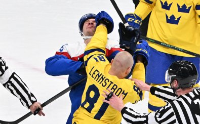 Slovakia’s Milos Kelemen (back) and Sweden’s Theodor Lennstrom engage in a fight during their men’s preliminary round group C match of the Beijing 2022 Winter Olympic Games ice hockey competition, at the Wukesong Sports Centre in Beijing on February 11, 2022. (Photo by ANTHONY WALLACE / AFP)