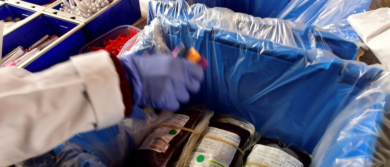 A picture shows blood packs stored in a box in a medical centre set up in the Salle des Illustres in the City Hall of Toulouse, southern France, on January 21, 2021, during the largest blood donation operation in France. – With some 3000 donors over four days, it is the largest blood collection in France and one of the top ones in Europe. (Photo by GEORGES GOBET / AFP)