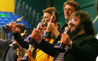 Lord of The Rings director Peter Jackson ( R) with Richard Taylor (2nd R) Michael Hedges (3rd R) and  other Oscar winners on stage with their Academy Awards in front of the 3000 assembled fans that turned out to see the Return of The King winners during Wellington city’s Oscar celebration at the Queens Wharf Event Centre, Wellington, New Zealand.18 March 2004. Seventeen of the Oscar winners were present with their 22 Oscars. AFP PHOTO/Dean TREML (Photo by DEAN TREML / AFP)