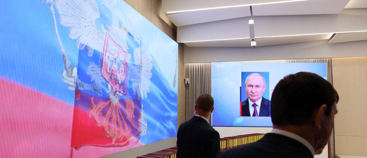 A screen displays a portrait of re-elected Russian President Vladimir Putin following the announcement of the official results in the three-day presidential election at Russia’s Central Electoral Commission (CEC) in Moscow on March 21, 2024. (Photo by STRINGER / AFP)