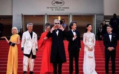German director Wim Wenders (C) takes photos as he arrives with (from L) Japanese actress Aoi Yamada, Japanese actor Min Tanaka, German photographer Donata Wenders, Japanese actor Koji Yakusho, Japanese actress Arisa Nakano and Japanese actor Tokio Emoto for the screening of the film „Perfect Days“ during the 76th edition of the Cannes Film Festival in Cannes, southern France, on May 25, 2023. (Photo by Valery HACHE / AFP)