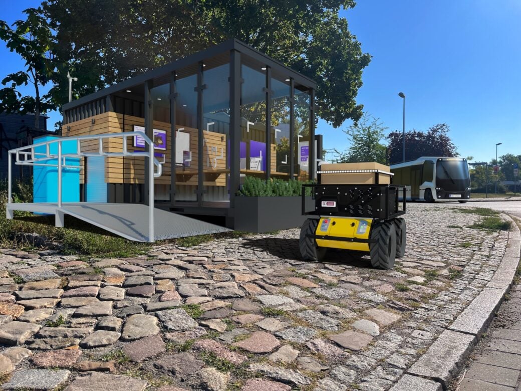 Zu sehen ist ein Lieferroboter vor einem Mobility Hub. Foto: IMIQ